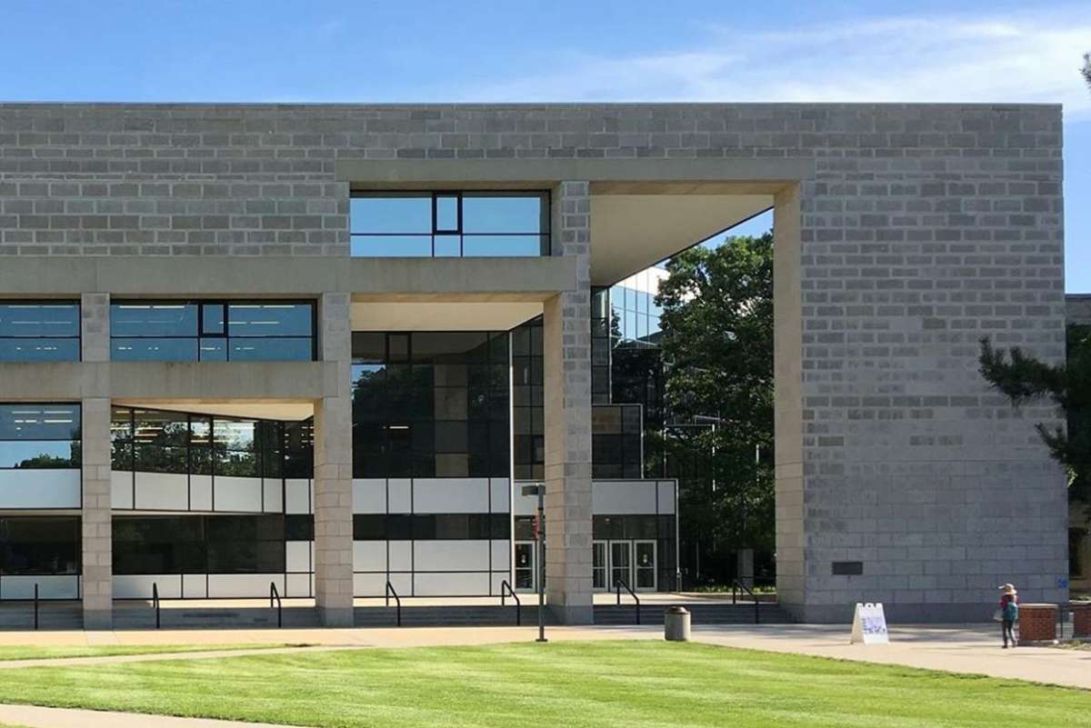 The exterior of Parks Library - a blocky building with rectangular windows and cutouts
